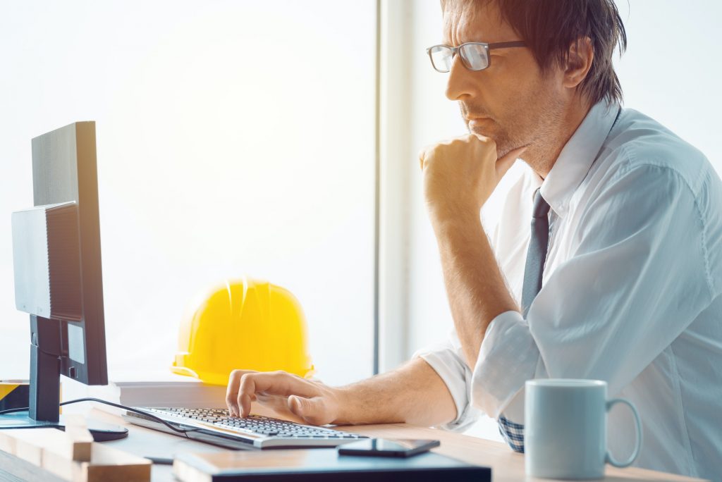 Architect and construction engineer working in office