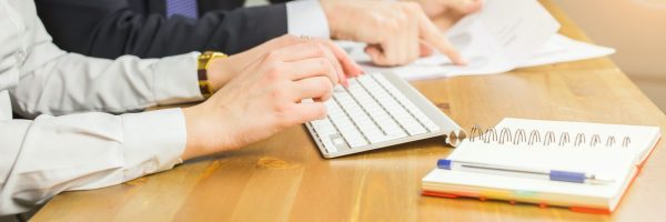 Technology, business and people concept - Woman's hand typing on keyboard